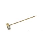 A LATE VICTORIAN YELLOW METAL, DIAMOND AND PEARL STICK PIN. (approx diamond weight 0.60ct, length