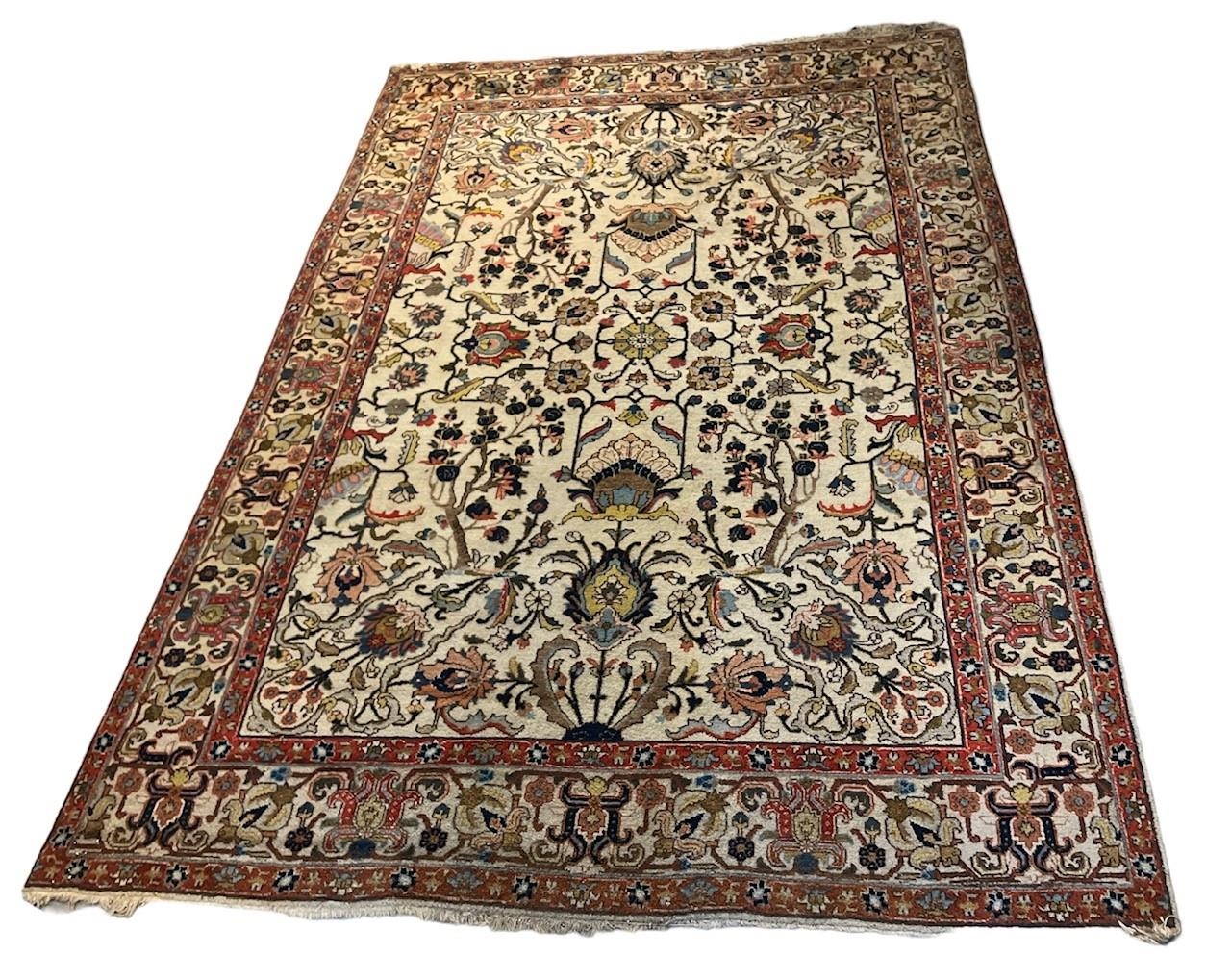 A PERSIAN ISFAHAN DESIGN CARPET/RUG On a beige ground with floral design. (233cm x 324cm)