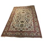 A PERSIAN ISFAHAN DESIGN CARPET/RUG On a beige ground with floral design. (233cm x 324cm)