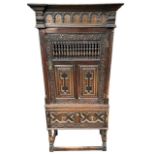 A 17TH CENTURY AND LATER CARVED OAK AND INLAID FOOD CUPBOARD/CABINET ON STAND The single door with