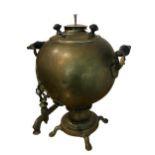 A LARGE 19TH CENTURY RUSSIAN BRASS SPHERICAL SAMOVAR Having two wooden handles raised on four hoof