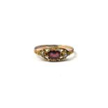 A VICTORIAN YELLOW METAL, GARNET AND SEED PEARL RING. (UK ring size P½, gross weight 1.1g, tested