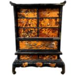 A 19TH CENTURY JAPANESE FAUX TORTOISESHELL AND MOTHER OF PEARL INLAID TABLE CABINET Decorated with
