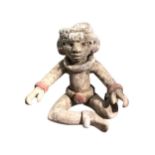 POSSIBLY TEOTHICAN, A POTTERY SEATED FIGURE OF A MAN. (h 7.2cm x w 7.8cm x depth 5.7cm)