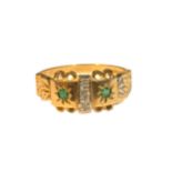 A 9CT GOLD, DIAMOND AND EMERALD GYPSY SET BUCKLE RING Having three central diamonds flanked either