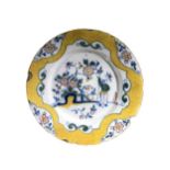 DELFT, A LATE 17TH/18TH CENTURY PLATE Having a yellow border met by a central figural garden
