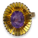 A YELLOW METAL AND AMETHYST OVAL RING (TESTED AS 18CT). (gallery 20mm x 17mm, UK ring size O,