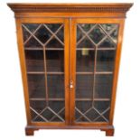 A 19TH CENTURY MAHOGANY FLOORSTANDING BOOKCASE With astra glazed doors open to reveal three