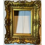 A 19TH CENTURY GILTWOOD AND GESSO SWEPT FRAME Decorated flowerheads and foliage. (rebate 16cm x 22.