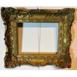 A GILTWOOD AND GESSO SWEPT FRAME Decorated flowerheads and foliage. (rebate 21cm x 26cm, frame