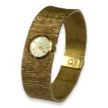 GIRARD-PERREGAUX, SWISS, A TEXTURED 9CT GOLD LADIES’ WRISTWATCH. (length 18.6cm x w 2cm, gross