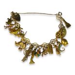 CHARM BRACELET HAVING AN ARRAY OF 9CT, 14CT, 18CT GOLD CHARMS AND OTHER YELLOW METAL CHARMS