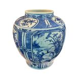A LARGE CHINESE BLUE AND WHITE VASE Decorated with flowers amongst foliage, slight flared lower