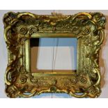 A 19TH CENTURY GILTWOOD AND GESSO SWEPT FRAME Decorated flowerheads and foliage. (rebate 16.5cm x