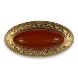 A LARGE VICTORIAN YELLOW METAL AND AMBER OVAL BROOCH (TESTED AS 18CT) Having chased and engraved