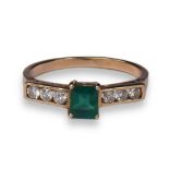 A 14CT GOLD, EMERALD AND DIAMOND RING Having central emerald cut flanked by three round cut diamonds