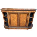 A 19TH CENTURY VICTORIAN FIGURED WALNUT AND INLAID CREDENZA With two panel doors opening to reveal a