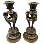 A PAIR OF 19TH CENTURY FRENCH EMPIRE NEOCLASSICAL CANDLESTICKS Supported on three eagle heads and
