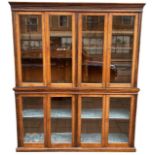 G. TROLLOPE & SONS, A 19TH CENTURY OAK GLAZED BOOKCASE With eight doors opening to reveal Adjustable