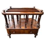 A 19TH CENTURY VICTORIAN WALNUT FOUR SECTION CANTERBURY Having a single drawer, raised on four legs.