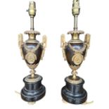 A PAIR OF LATE 19TH CENTURY FRENCH GILT BRONZE TWIN HANDLED URNS Decorated with acanthus leaf and