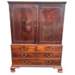 AN 18TH CENTURY GEORGE III SOLID MAHOGANY DWARF LINEN PRESS The panel doors opening to reveal five