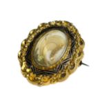 A VICTORIAN YELLOW METAL MOURNING BROOCH/PENDANT (TESTED AS 14CT) Having chased and niello