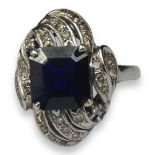 AN 18CT WHITE GOLD, SAPPHIRE AND DIAMOND CLUSTER RING Square cut sapphire surrounded by a cluster of