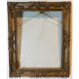 A GILT GESSO FRAME Decorated with shells and scrolling foliage. (rebate 40cm x 51.5cm, frame 53cm