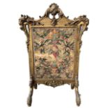 MANNER OF WILLIAM KENT, A 19TH CENTURY CARVED GILTWOOD EMBROIDERED PANEL FIRE SCREEN The top with