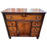 A 19TH CENTURY REGENCY PERIOD (POSSIBLY IRISH) MAHOGANY SIDE CABINET The shaped top above five