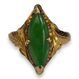 A CHINESE 18CT GOLD AND GREEN JADE RING Having character marks to inner shank, jade being a cabochon