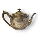 A GEORGIAN SILVER OVAL TEAPOT With carved wooden handle and finial, flutes to body and engraved