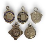 A COLLECTION OF FIVE EARLY 20TH CENTURY SILVER AMATEUR FOOTBALL POCKET WATCH FOBS Comprising two