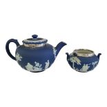 WEDGWOOD, AN EARLY 20TH CENTURY BLUE JASPER TEAPOT AND SUGAR BOWL Silver rim, both applied with