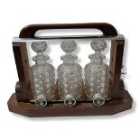 BACCARAT, FRANCE, AN ATTRACTIVE LATE ART DECO TEAK AND SILVER PLATED TANTALUS Containing three