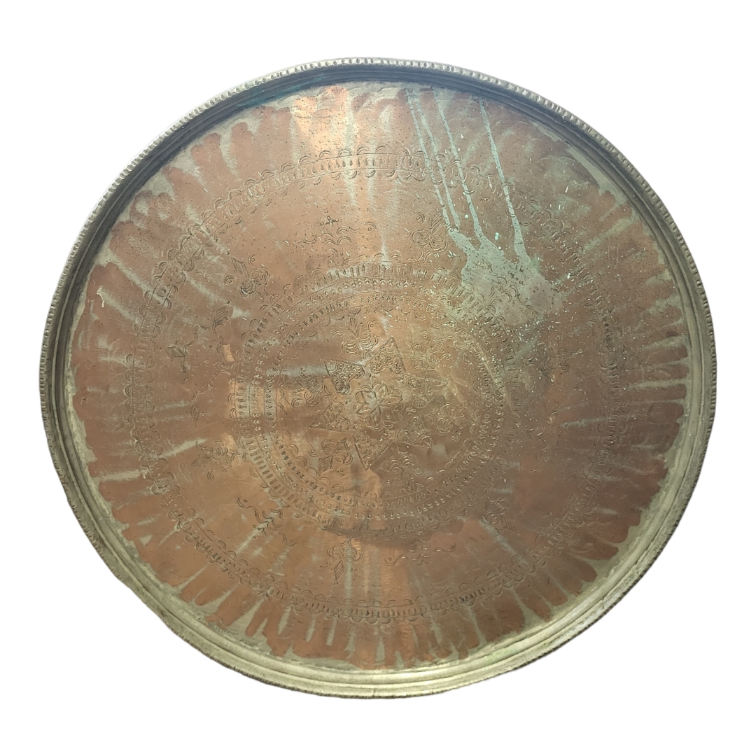 A LARGE EARLY 19TH CENTURY CIRCULAR MIDDLE EASTERN COPPER SERVING TRAY Centrally hand hammered
