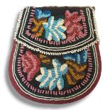 AN ANTIQUE NATIVE AMERICAN INDIAN BEADWORK POUCH Having double sided coloured glass beadwork