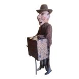 A LATE 19TH/EARLY 20TH CENTURY CONTINENTAL WIND UP TIN TOY OF GROTESQUE BARREL ORGAN PLAYER Possibly