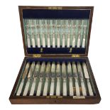 AN EARLY 20TH CENTURY SET OF SILVER PLATE AND MOTHER OF PEARL DESSERT KNIVES AND FORKS Twelve knives