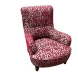 AN EDWARDIAN PERIOD EASY ARMCHAIR Newly upholstered in a wine red cut velvet, on turned legs