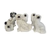 A PAIR OF LATE 19TH CENTURY STAFFORDSHIRE POTTERY DOGS Together with three single Staffordshire dogs