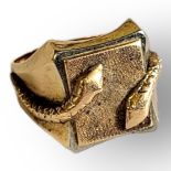 A VINTAGE YELLOW METAL GENTS SIGNET RING Having raised entwined snakes and textured finish. (size