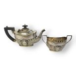 AN EARLY 20TH CENTURY SILVER BATCHELOR'S TEAPOT Having ebonised wooden handle and finial and