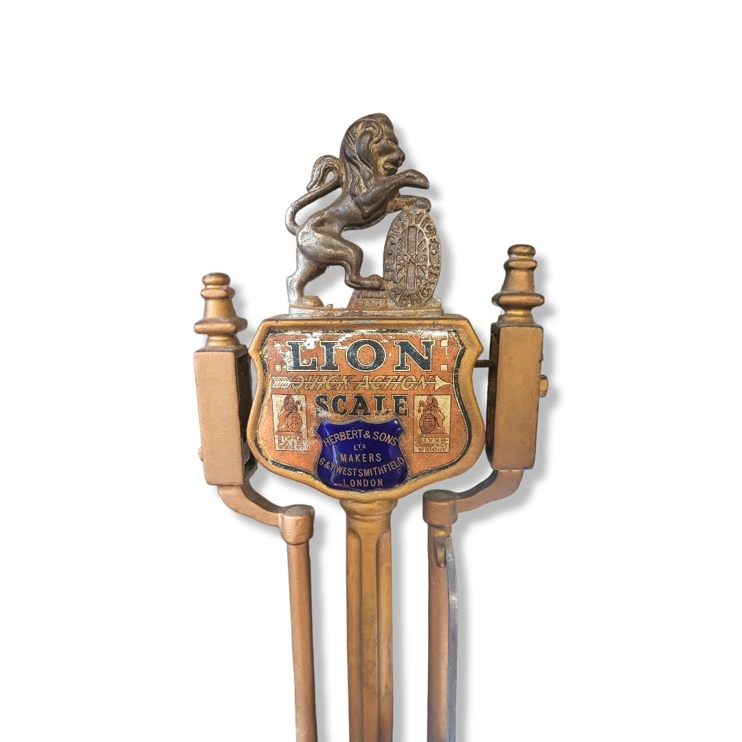 A SET OF EARLY 20TH CENTURY PAINTED CAST IRON BALANCE SCALES Having a lion and shield form finial - Image 2 of 2