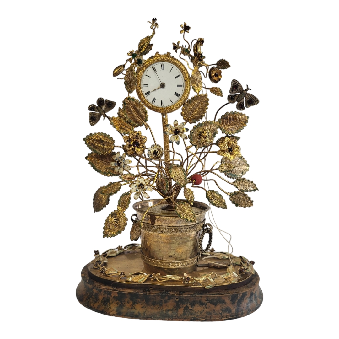 A 19TH CENTURY FRENCH GILT BRONZE AND ENAMEL MANTLE CLOCK Having a white dial with organic leaves