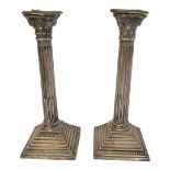 A PAIR OF EARLY 20TH CENTURY SILVER CANDLESTICKS Classical column form with fluted decoration and