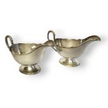 A PAIR OF EARLY 20TH CENTURY SAUCE BOATS Having a single handle and scrolled edge, hallmarked