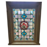 A LATE VICTORIAN LEADED STAINED GLASS COLOURED WINDOW Centrally painted with a circular medallion of