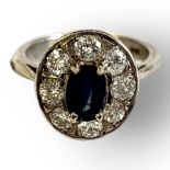 AN EARLY 20TH CENTURY 18CT WHITE GOLD, SAPPHIRE AND DIAMOND RING Having an oval central cut sapphire